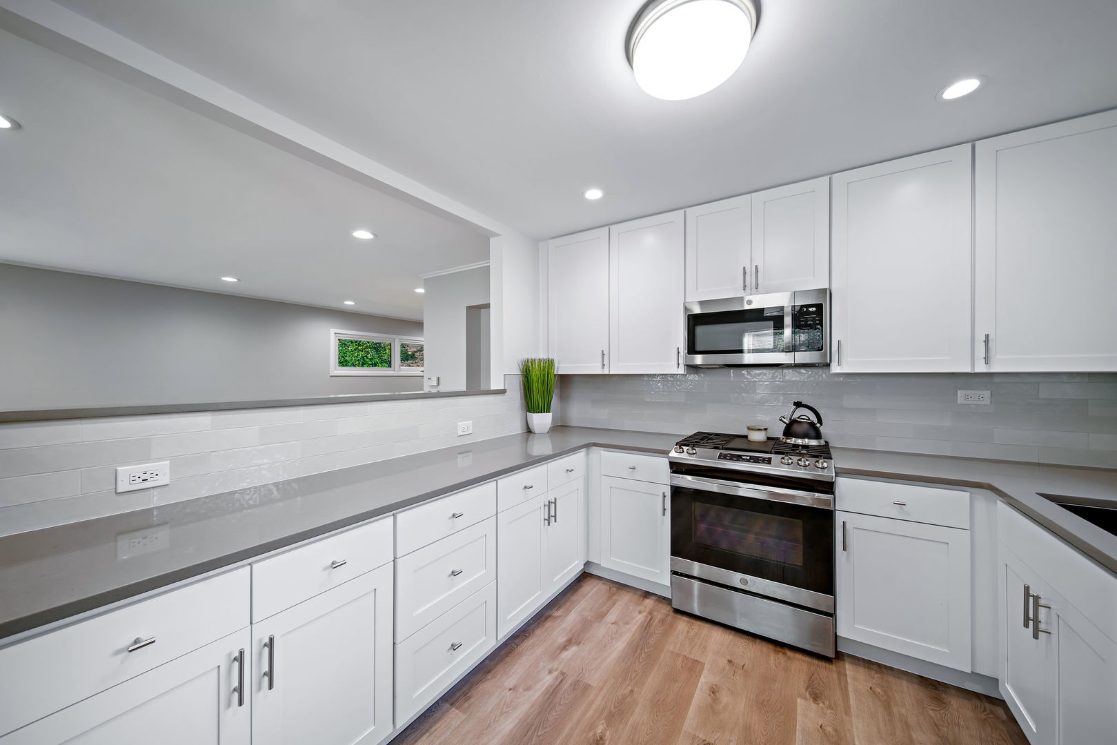 405 Marshall Road Northbrook, IL 60062 - Photo 13 of 27 a kitchen with granite countertop white cabinets and white appliances
