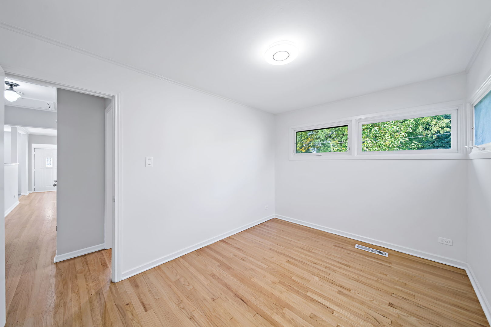 405 Marshall Road Northbrook, IL 60062 - Photo 18 of 27 an empty room with wooden floor and windows