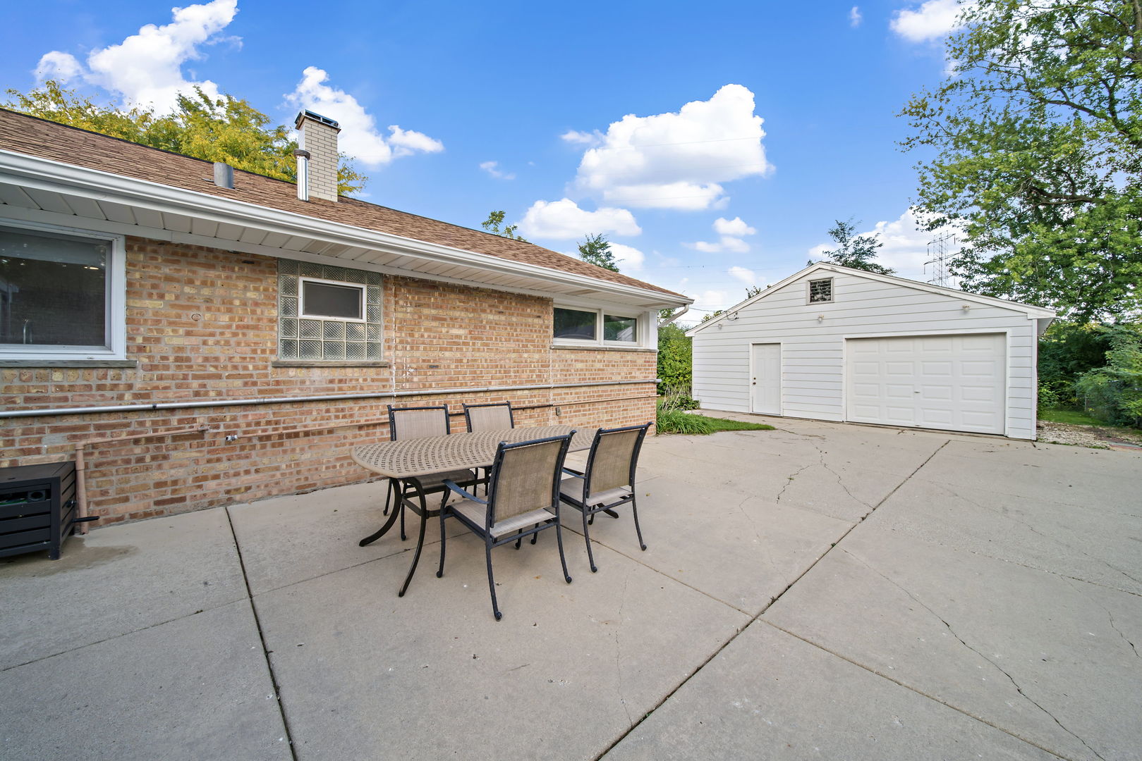405 Marshall Road Northbrook, IL 60062 - Photo 22 of 27 a view of a patio with table and chairs and potted plants
