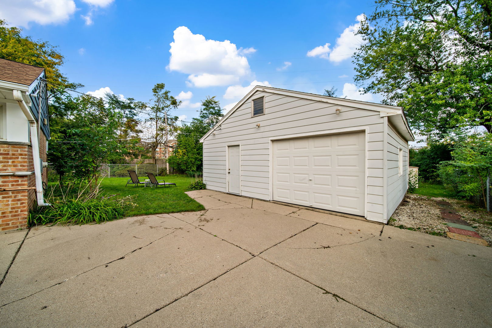 405 Marshall Road Northbrook, IL 60062 - Photo 26 of 27 a view of a white house with a yard and potted plants