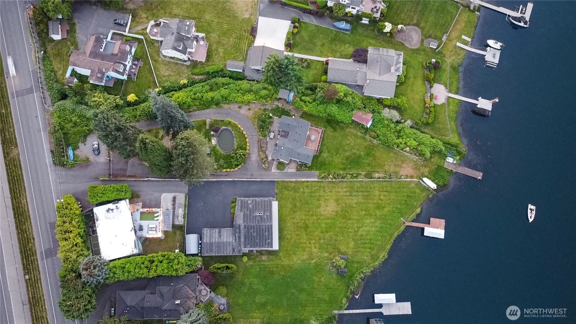 5104 Northwest Sammamish Road Issaquah, WA 98027 - Photo 22 of 24 an aerial view of a house with a garden and lake view