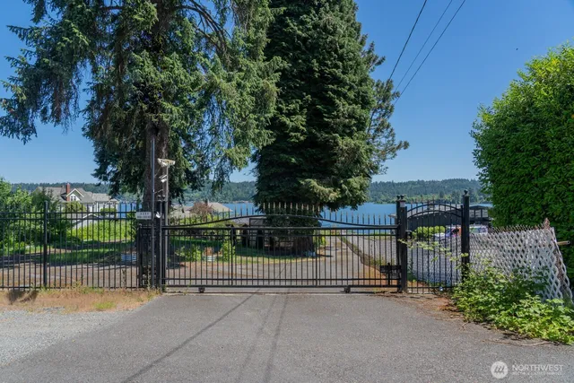 a view of a patio with table and chairs under an umbrella with a fire pit