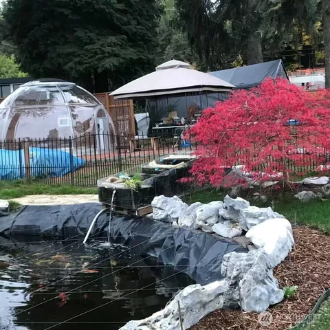 a view of swimming pool with sitting area