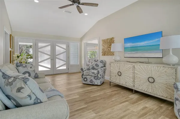 a view of a dining room with furniture a rug and wooden floor