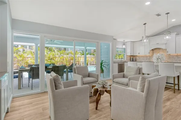 a kitchen with stainless steel appliances granite countertop a sink a stove and refrigerator