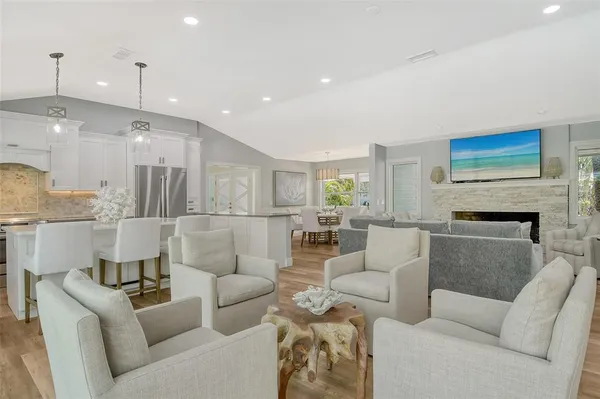 a living room with furniture a fireplace and a chandelier