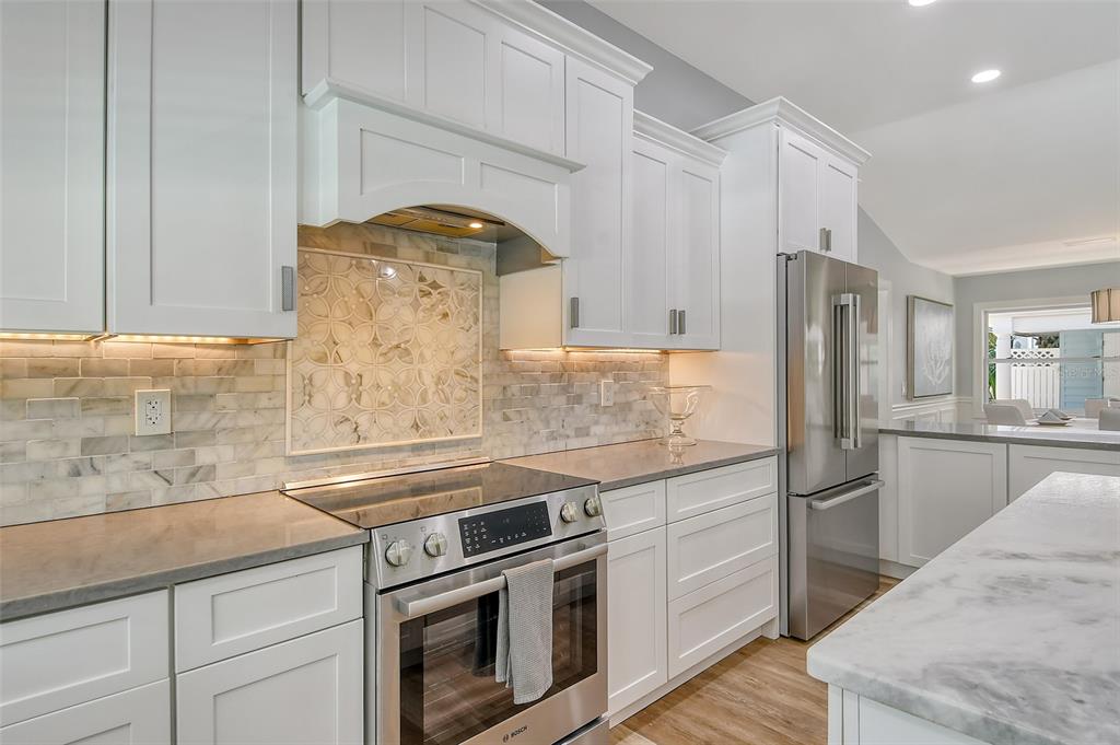 4852 Featherbed Lane Sarasota, FL 34242 - Photo 28 of 79 a kitchen with stainless steel appliances granite countertop a sink a stove and refrigerator