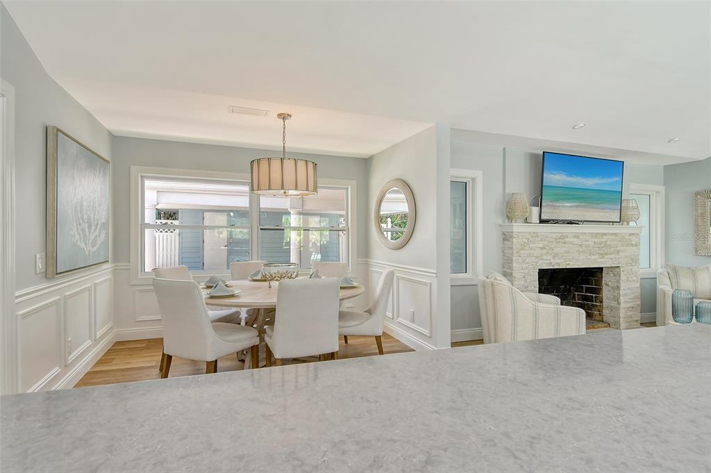 4852 Featherbed Lane Sarasota, FL 34242 - Photo 30 of 79 a living room with furniture a fireplace and a chandelier