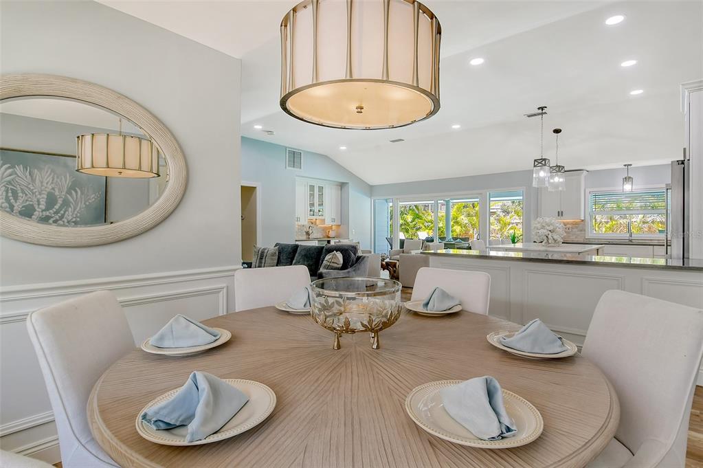 4852 Featherbed Lane Sarasota, FL 34242 - Photo 32 of 79 a dining room with furniture a chandelier and wooden floor