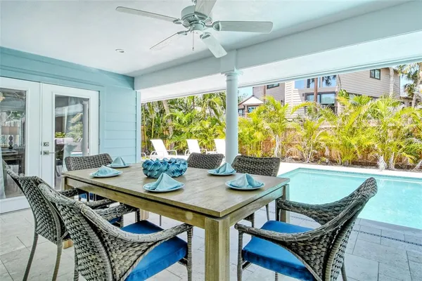 a view of a house with a large window and potted plants