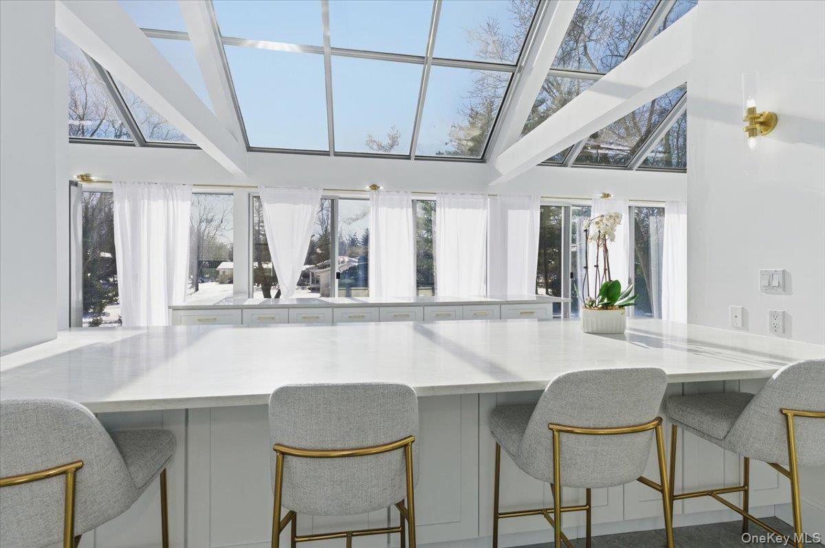 454 East Shore Road Great Neck, NY 11024 - Photo 19 of 48 a kitchen with a table and chairs
