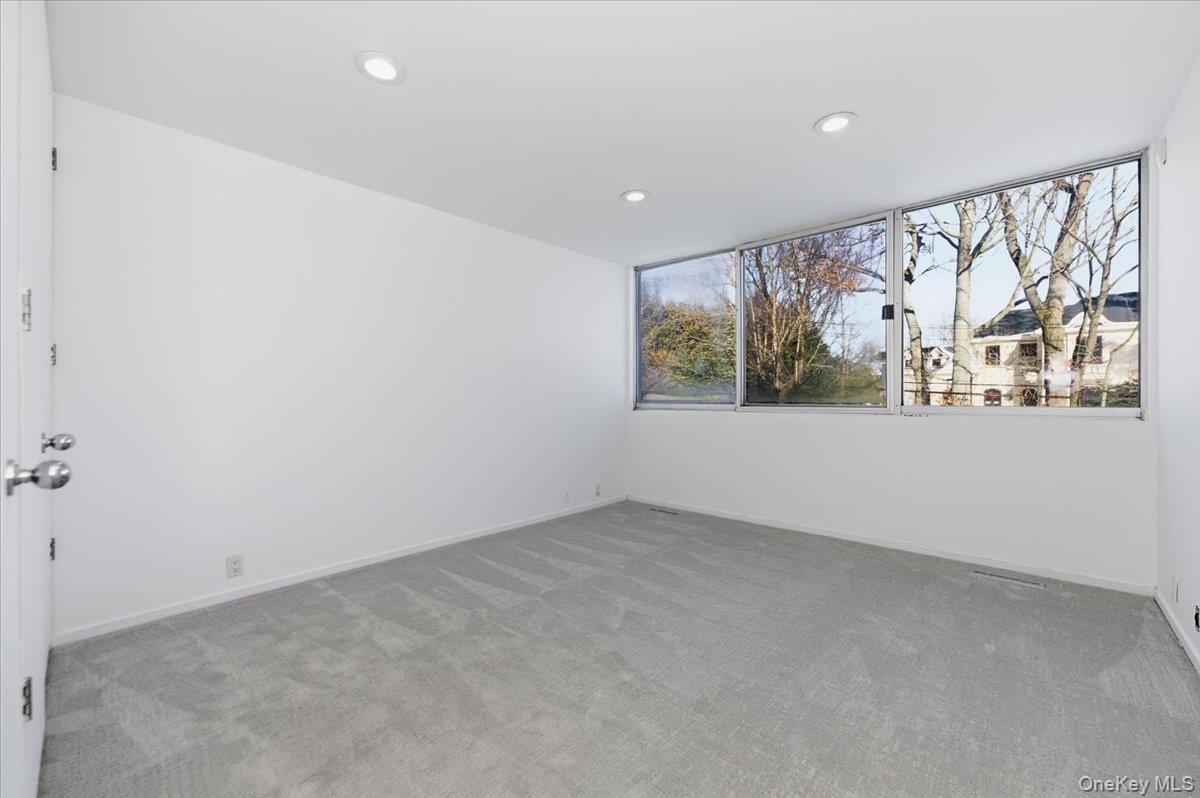 454 East Shore Road Great Neck, NY 11024 - Photo 25 of 48 an empty room with windows