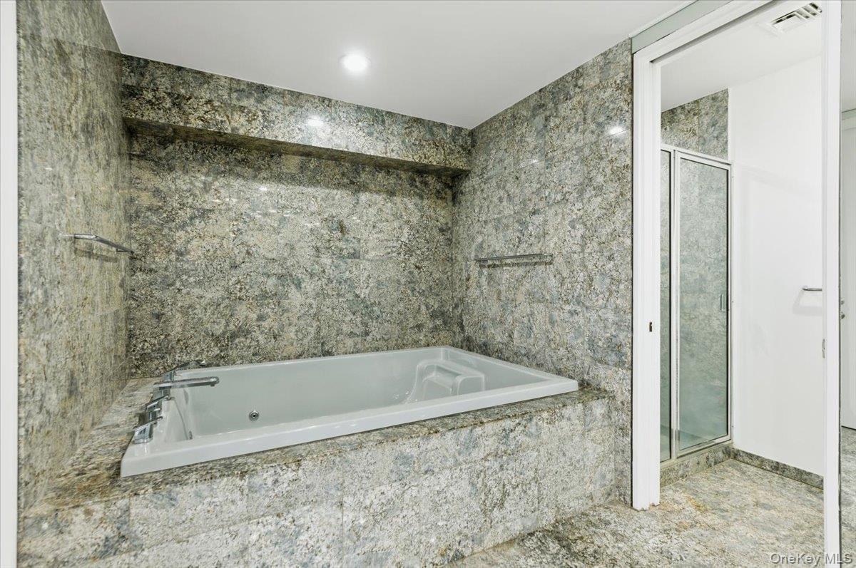 454 East Shore Road Great Neck, NY 11024 - Photo 34 of 48 a bathroom with a bathtub and shower