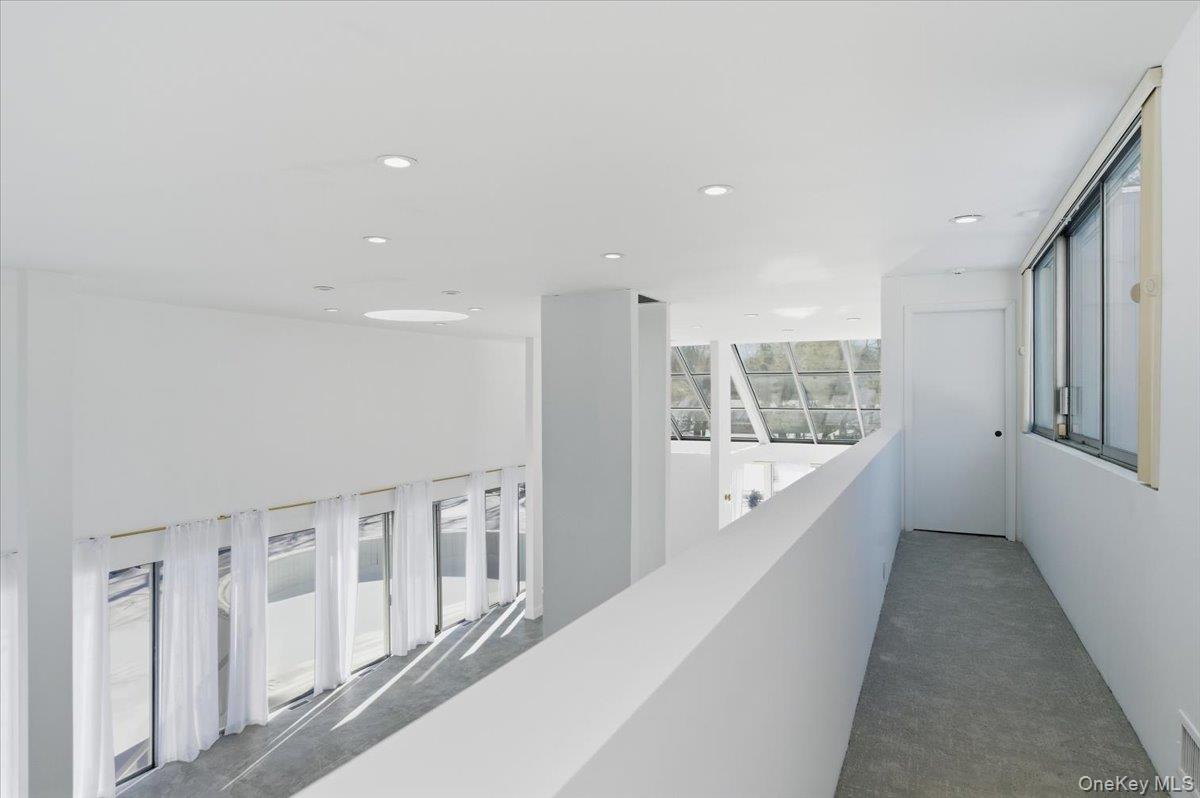 454 East Shore Road Great Neck, NY 11024 - Photo 35 of 48 a hallway with windows