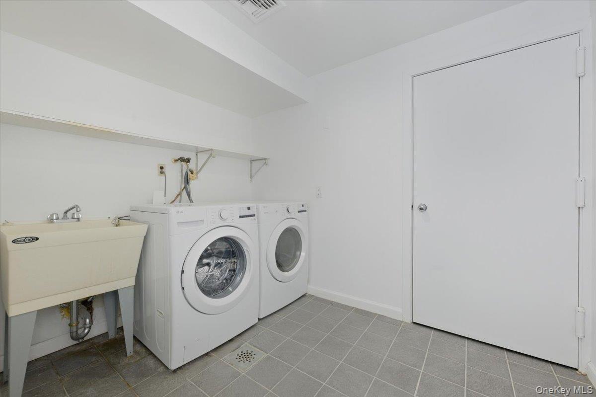 454 East Shore Road Great Neck, NY 11024 - Photo 37 of 42 a utility room with dryer and washer
