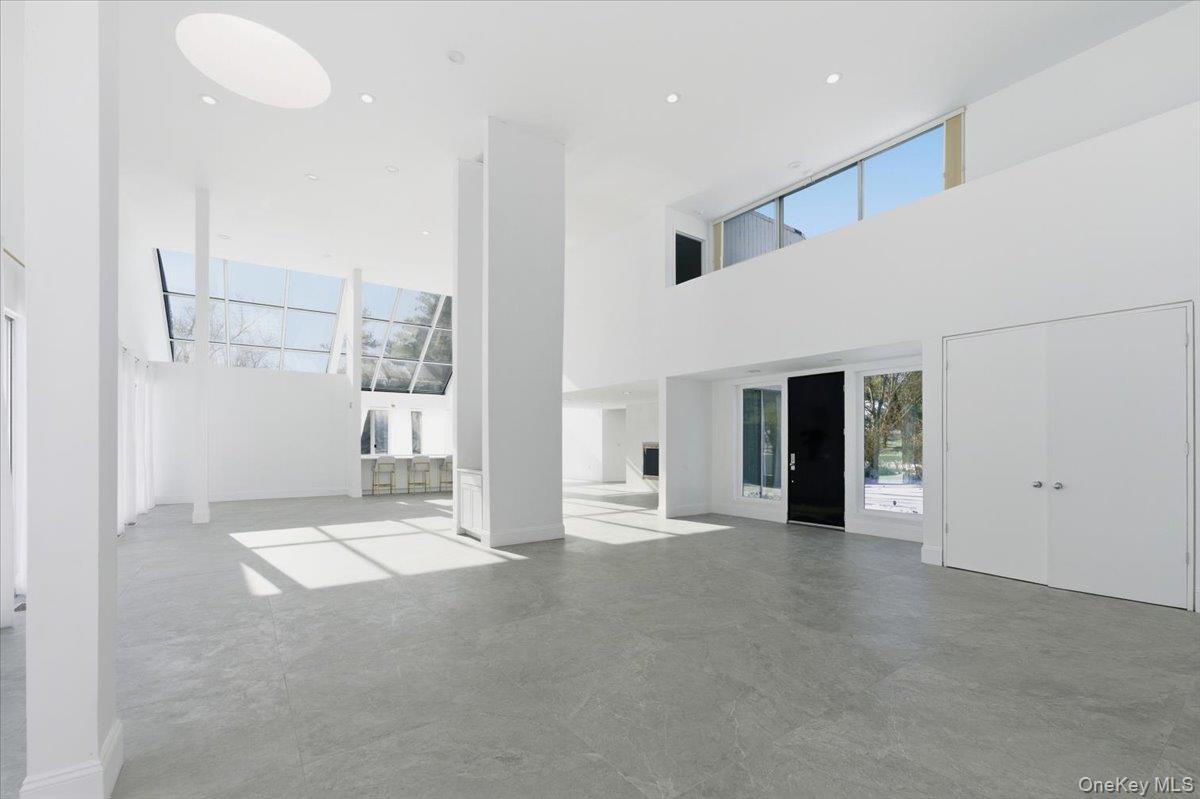 454 East Shore Road Great Neck, NY 11024 - Photo 4 of 42 a view of an empty room with kitchen and a window
