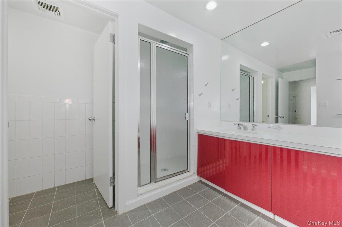 454 East Shore Road Great Neck, NY 11024 - Photo 42 of 48 a bathroom with a sink and a mirror