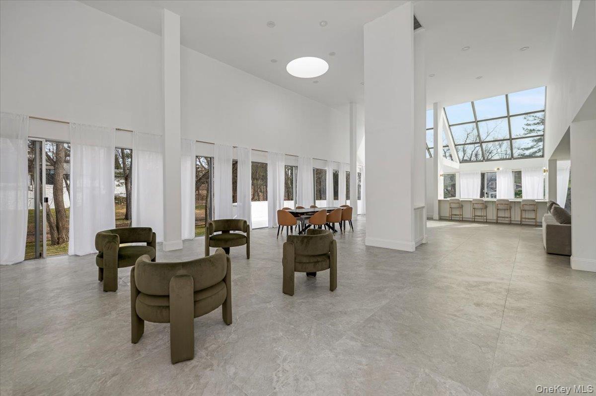 454 East Shore Road Great Neck, NY 11024 - Photo 6 of 48 a living room with furniture and a dining table