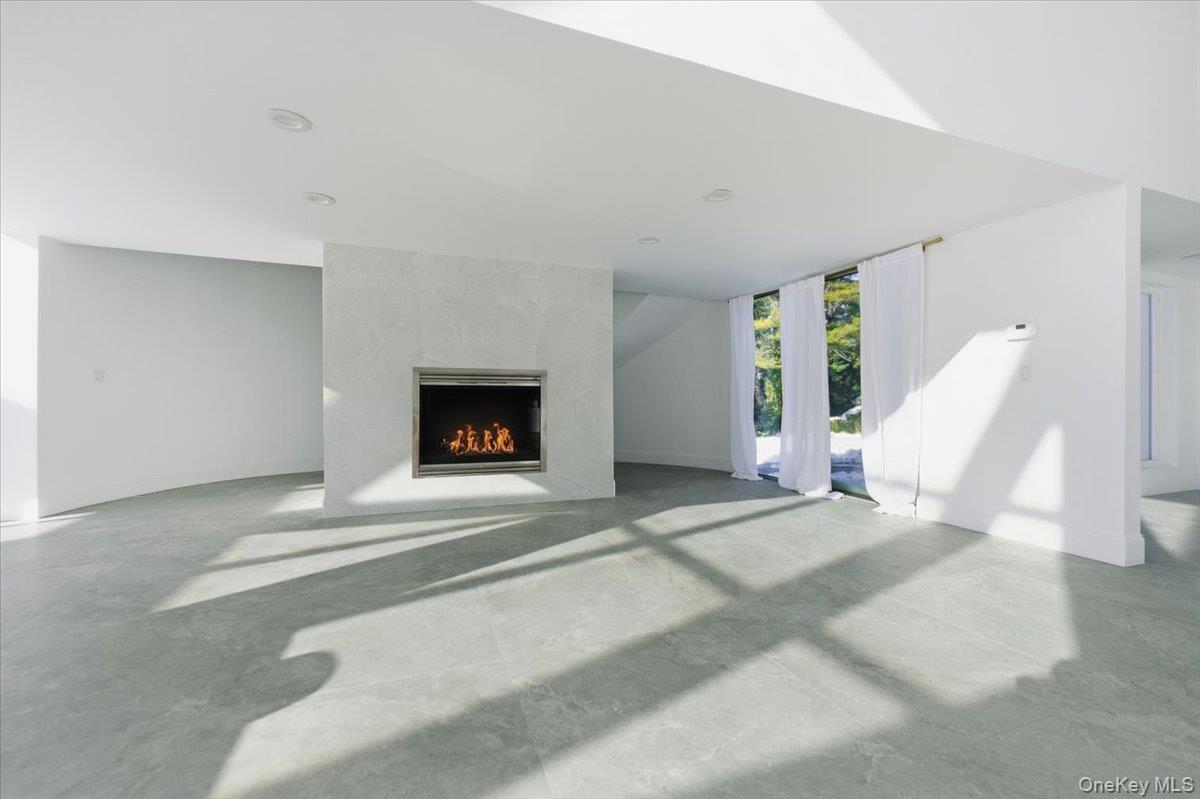 454 East Shore Road Great Neck, NY 11024 - Photo 8 of 42 a view of a livingroom with furniture and a fireplace