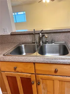 a kitchen with stainless steel appliances a sink stove and cabinets
