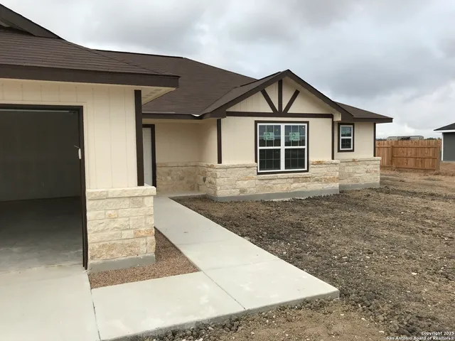 a view of front of house with wooden deck and shower