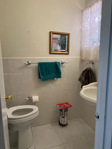 a bathroom with a toilet a sink and a mirror