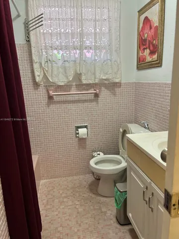 a bathroom with a toilet and a sink