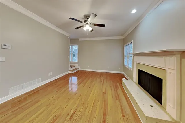 wooden floor in an empty room with a fireplace