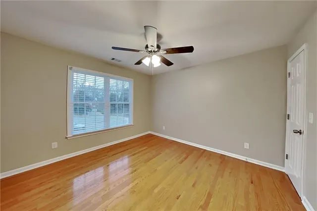 wooden floor in an empty room with a window