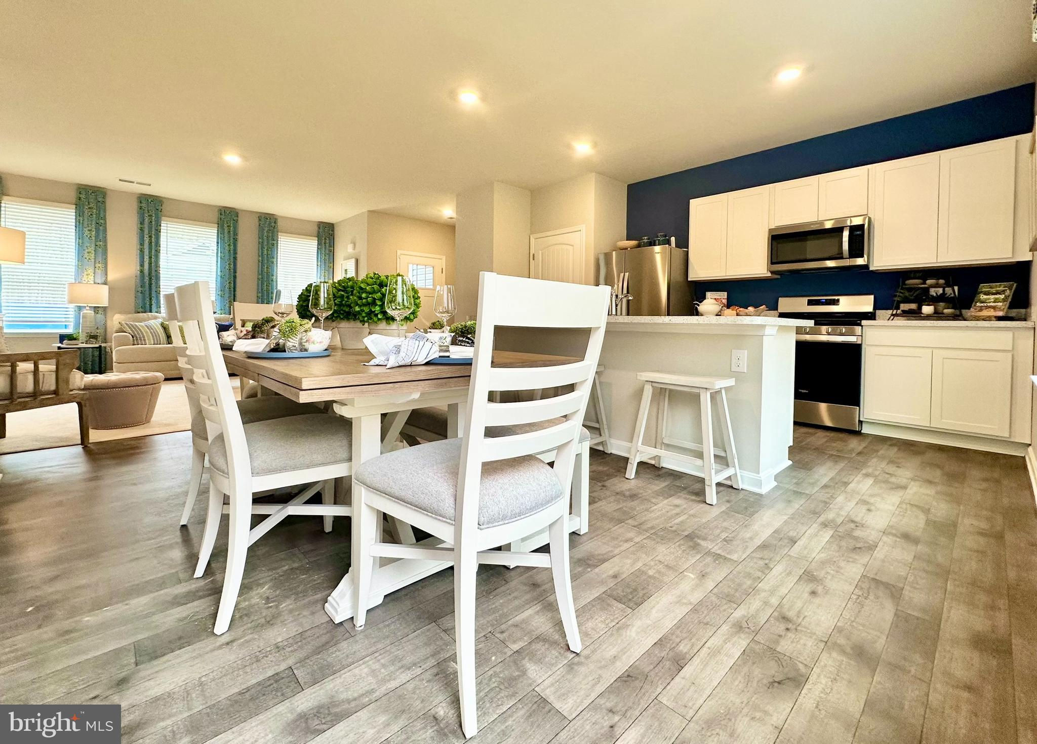 104 Red Haven Way Dover, DE 19904 - Photo 13 of 33 a kitchen with a dining table chairs counter space cabinets and appliances