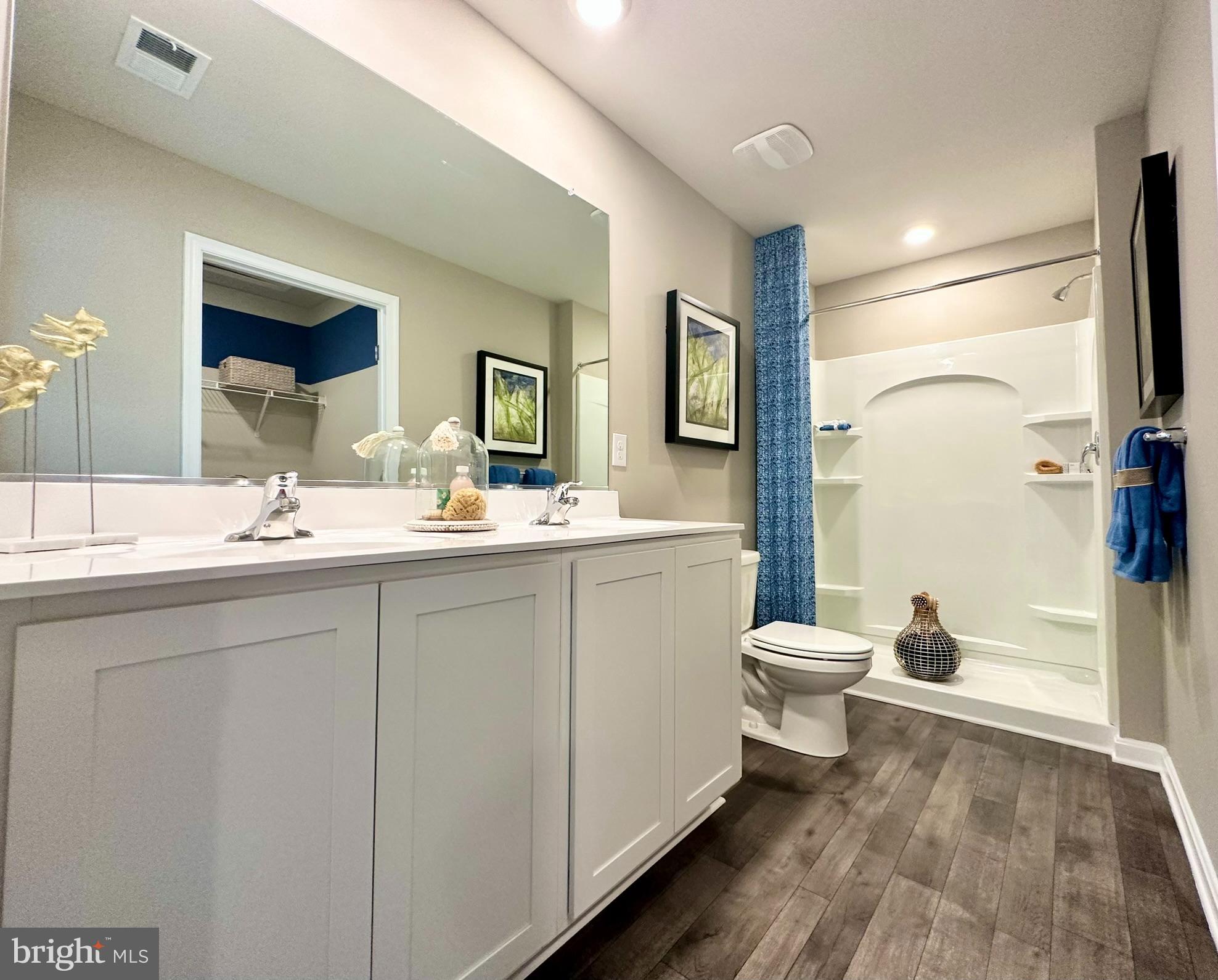 104 Red Haven Way Dover, DE 19904 - Photo 23 of 33 a bathroom with a toilet sink double vanity and mirror