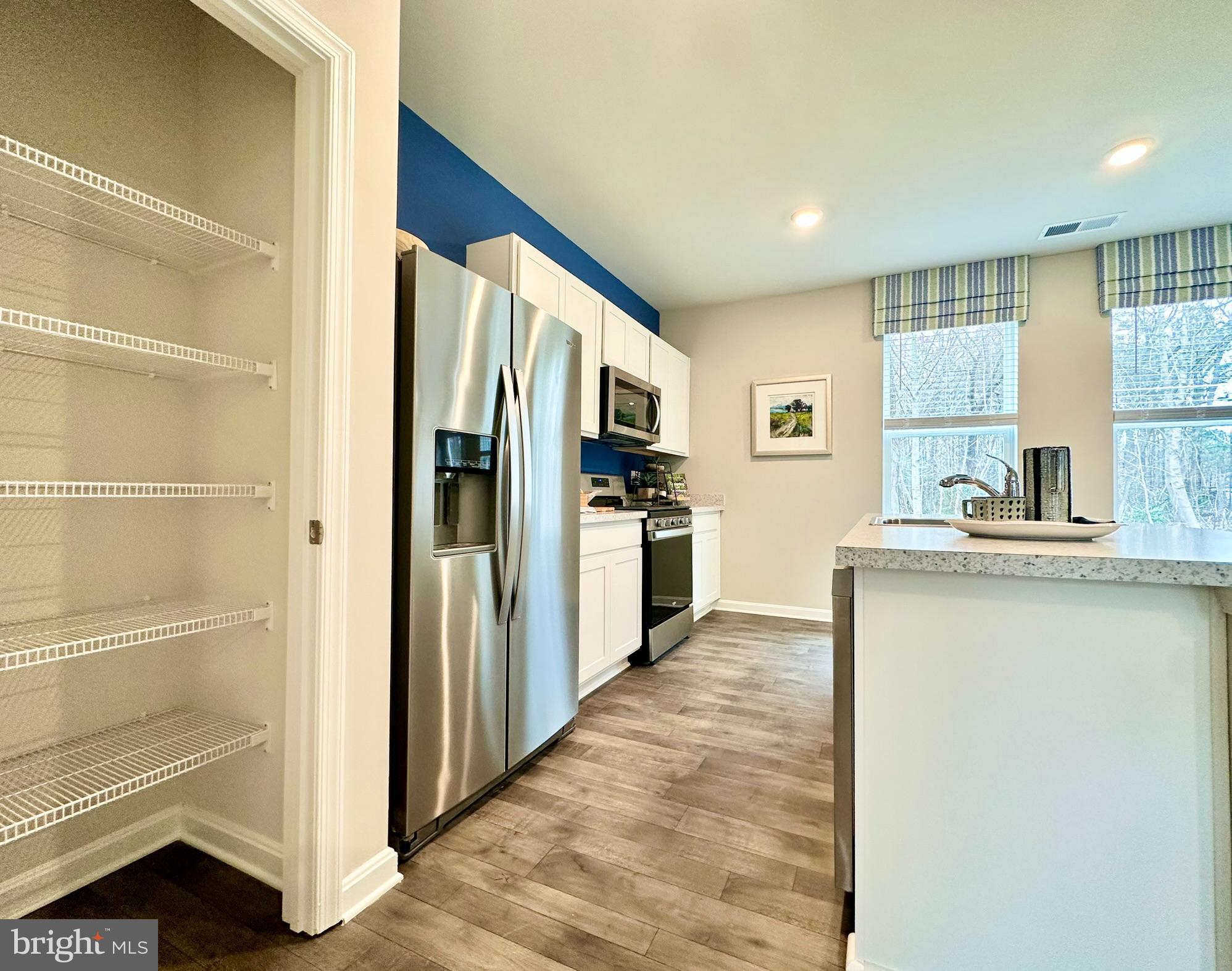 104 Red Haven Way Dover, DE 19904 - Photo 10 of 33 a kitchen with stainless steel appliances granite countertop a refrigerator and a sink
