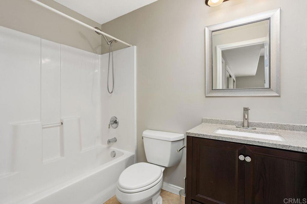 2380 Jefferson Street, Unit B Carlsbad, CA 92008 - Photo 16 of 25 a bathroom with a toilet a sink a bath tub and a mirror