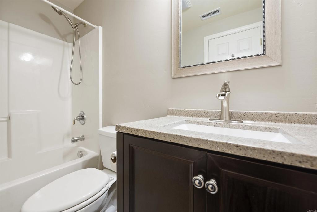 2380 Jefferson Street, Unit B Carlsbad, CA 92008 - Photo 17 of 25 a bathroom with a granite countertop sink toilet and shower