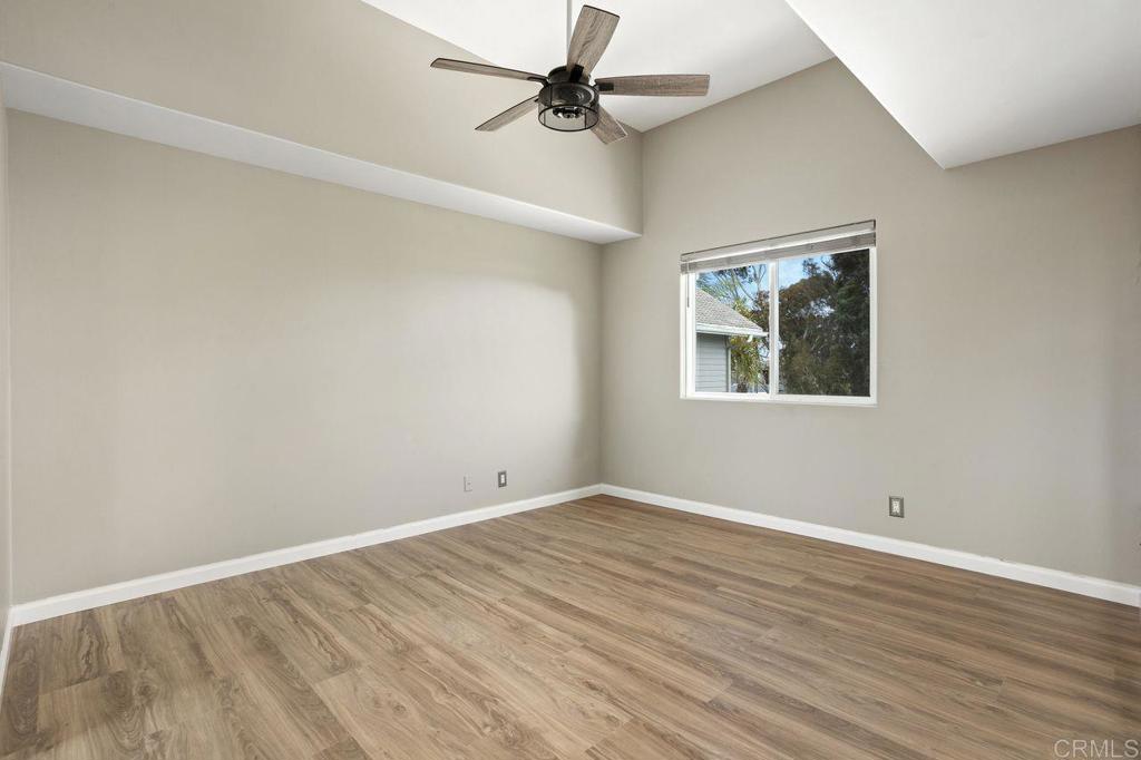 2380 Jefferson Street, Unit B Carlsbad, CA 92008 - Photo 18 of 25 an empty room with wooden floor ceiling fan and windows
