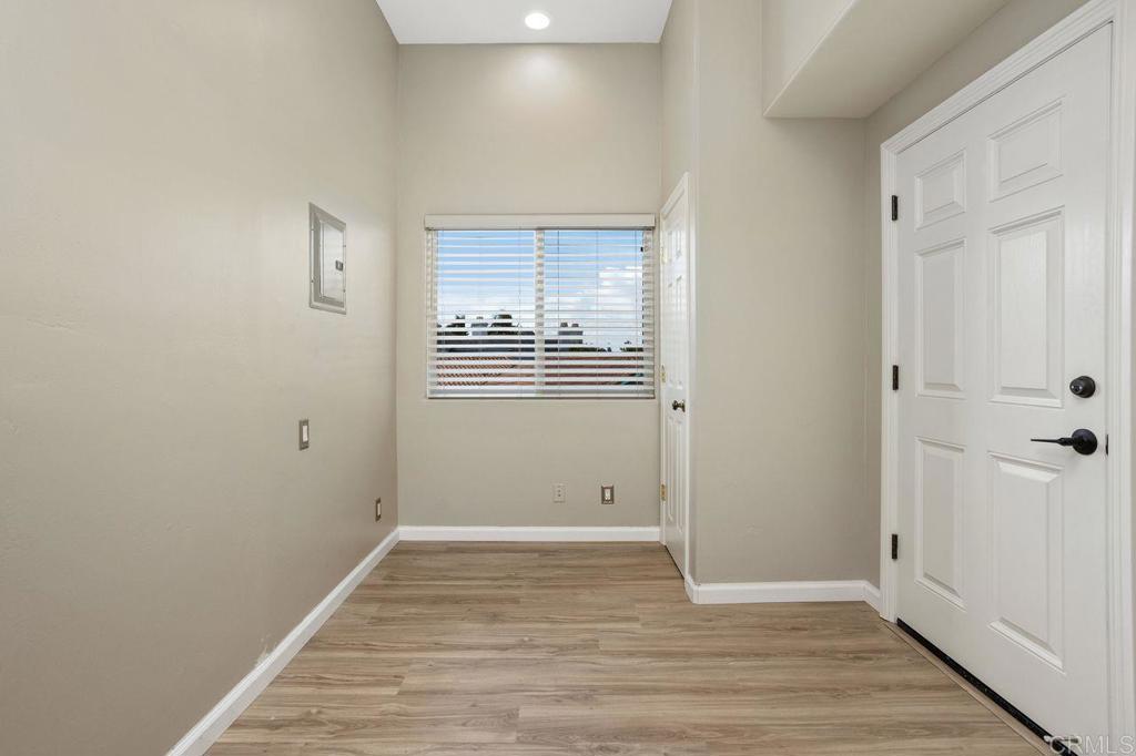 2380 Jefferson Street, Unit B Carlsbad, CA 92008 - Photo 20 of 25 a view of an empty room with wooden floor and a window