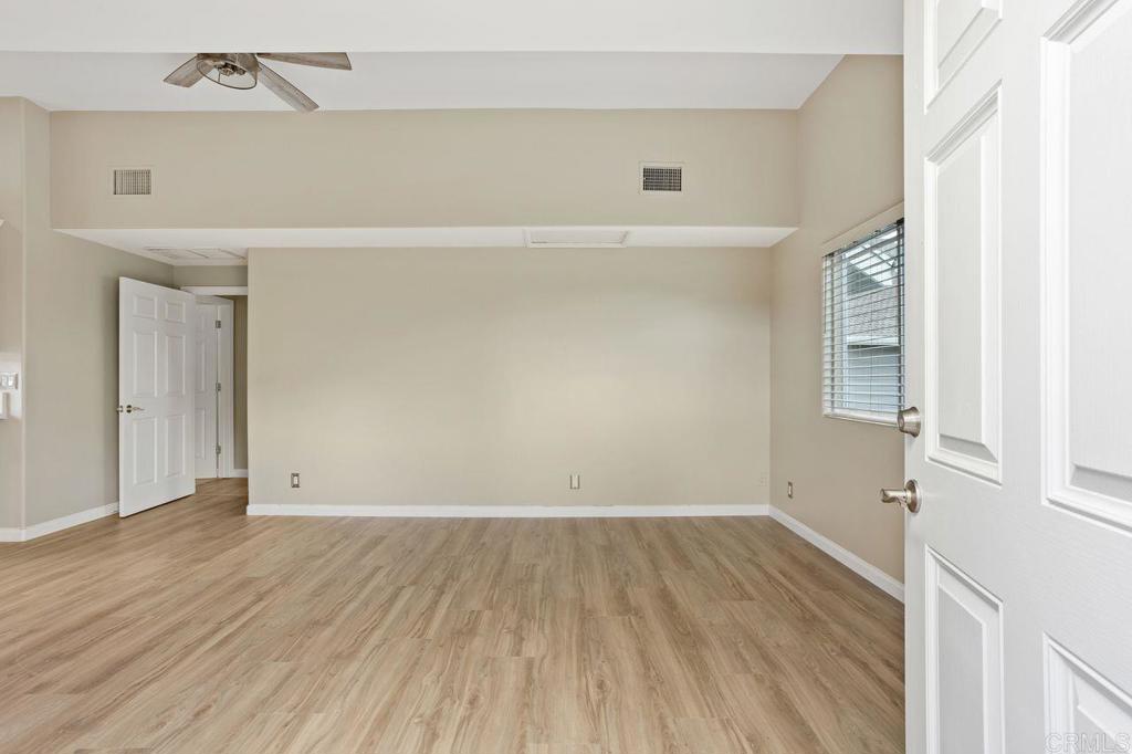 2380 Jefferson Street, Unit B Carlsbad, CA 92008 - Photo 8 of 25 an empty room with wooden floor and windows