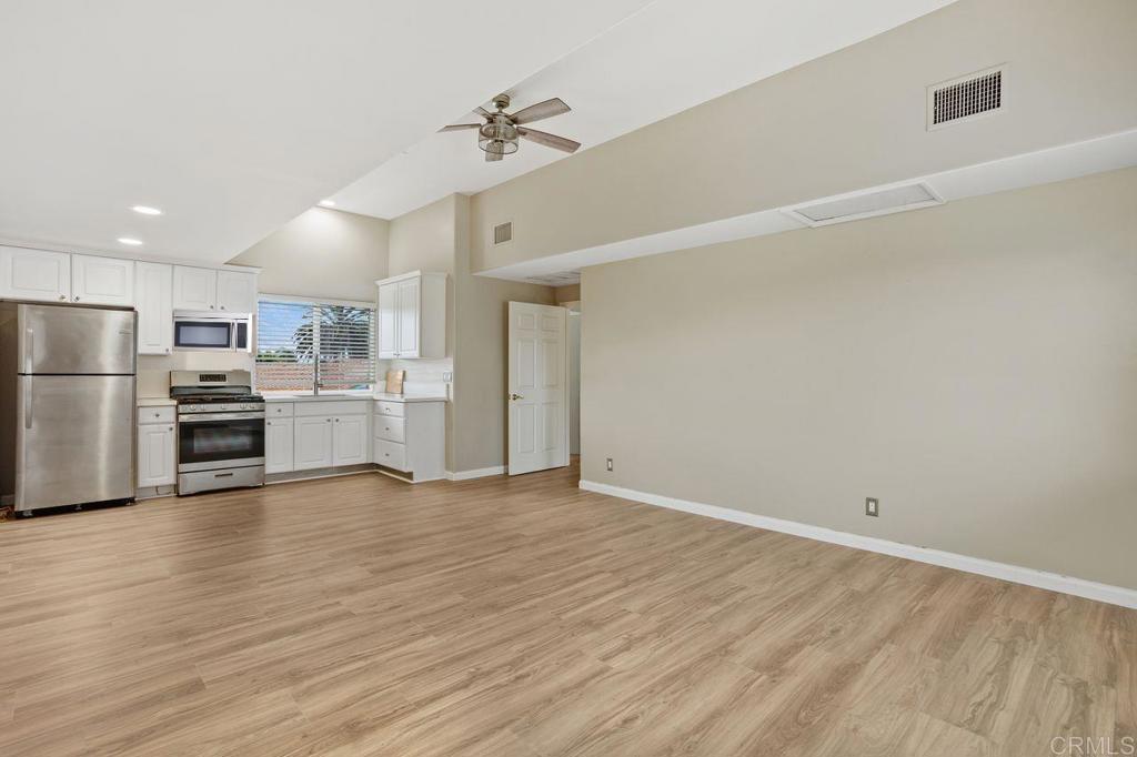 2380 Jefferson Street, Unit B Carlsbad, CA 92008 - Photo 10 of 25 a view of a kitchen with wooden floor electronic appliances and window