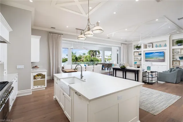 a large white kitchen with a large window