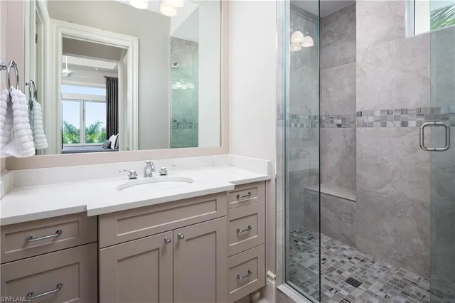 a bathroom with a shower sink and mirror