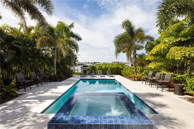 a view of swimming pool with chairs
