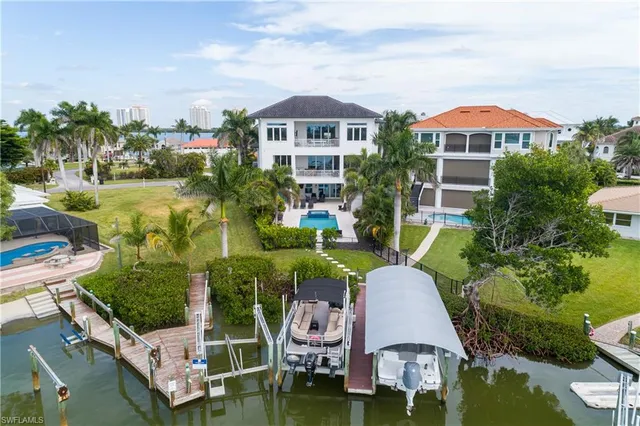 an aerial view of a house with a garden and lake view