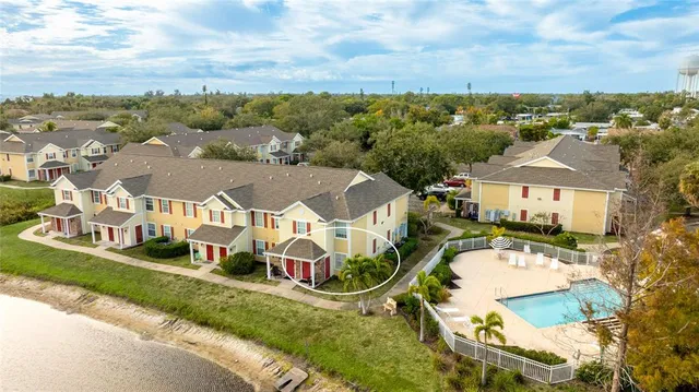 an aerial view of residential houses with outdoor space and city view
