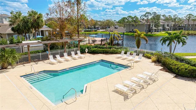 a swimming pool with outdoor seating and yard