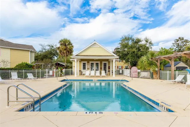 a view of house with swimming pool and porch