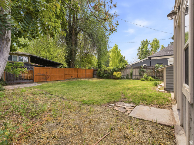 225 South 300 East Provo, UT 84606 - Photo 24 of 30 Expansive backyard featuring a partial wooden privacy fence and mature trees