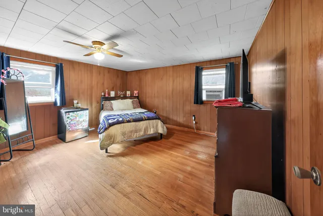 a bedroom with furniture and a large window