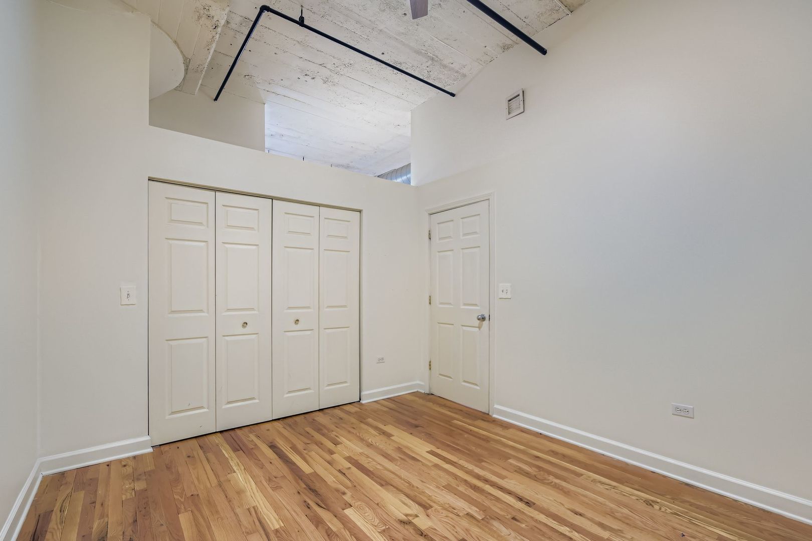 221 East Cullerton Street, Unit 317 Chicago, IL 60616 - Photo 13 of 16 a view of a room with wooden floor