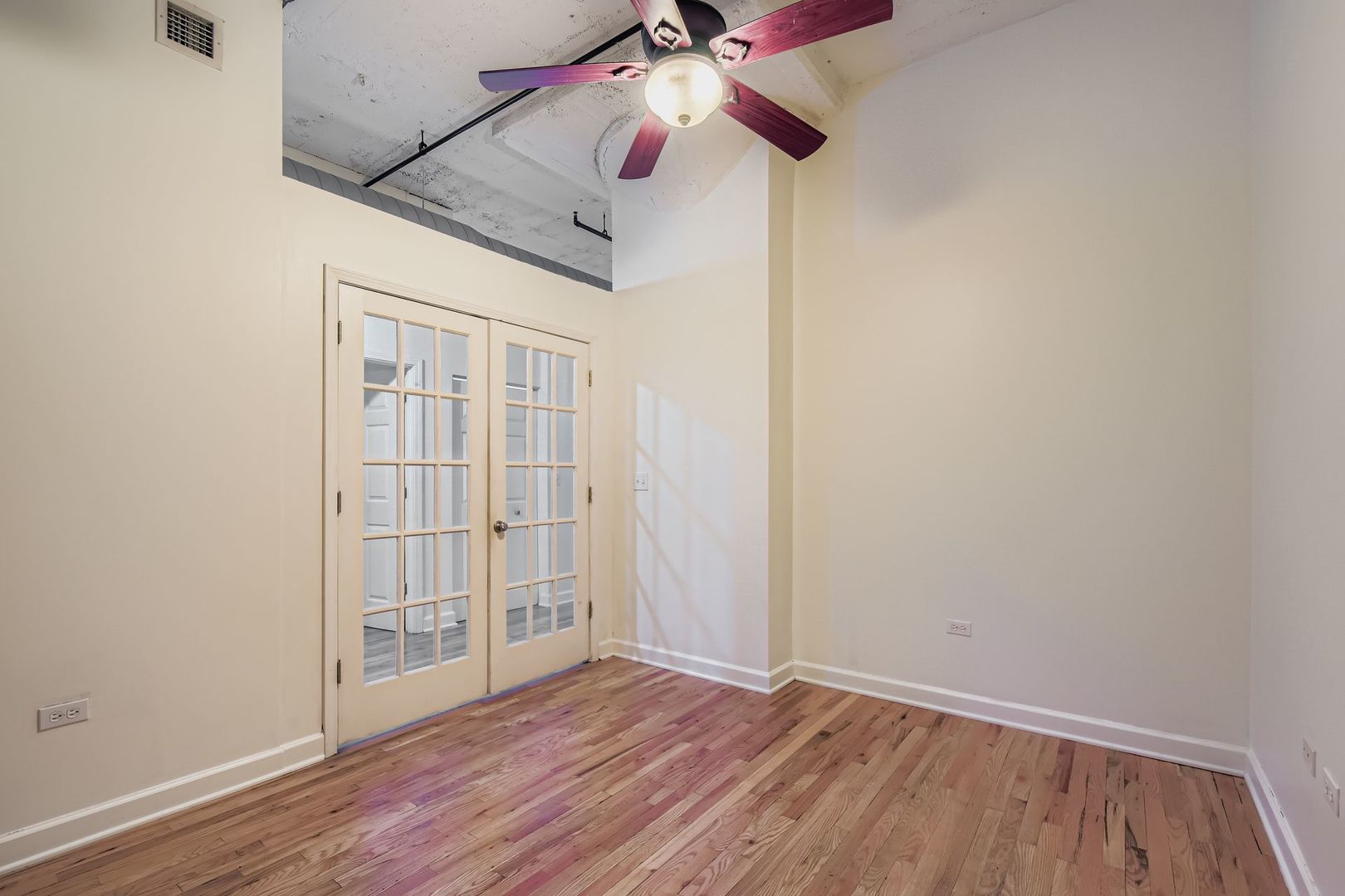 221 East Cullerton Street, Unit 317 Chicago, IL 60616 - Photo 14 of 16 wooden floor in an empty room with a window