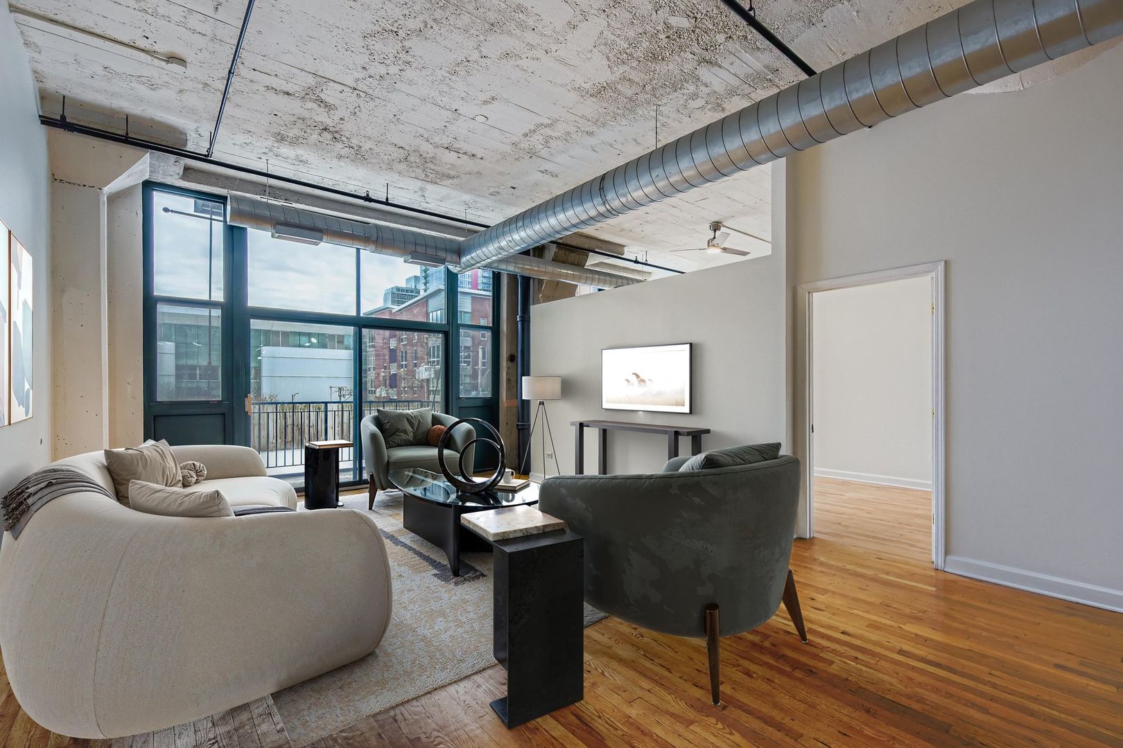 221 East Cullerton Street, Unit 317 Chicago, IL 60616 - Photo 2 of 16 a living room with furniture and a large window